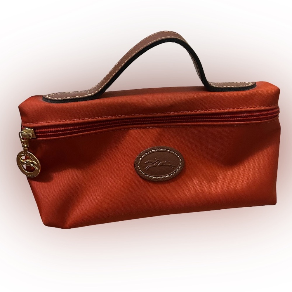 Longchamp Le Pliage in orange w white interior.